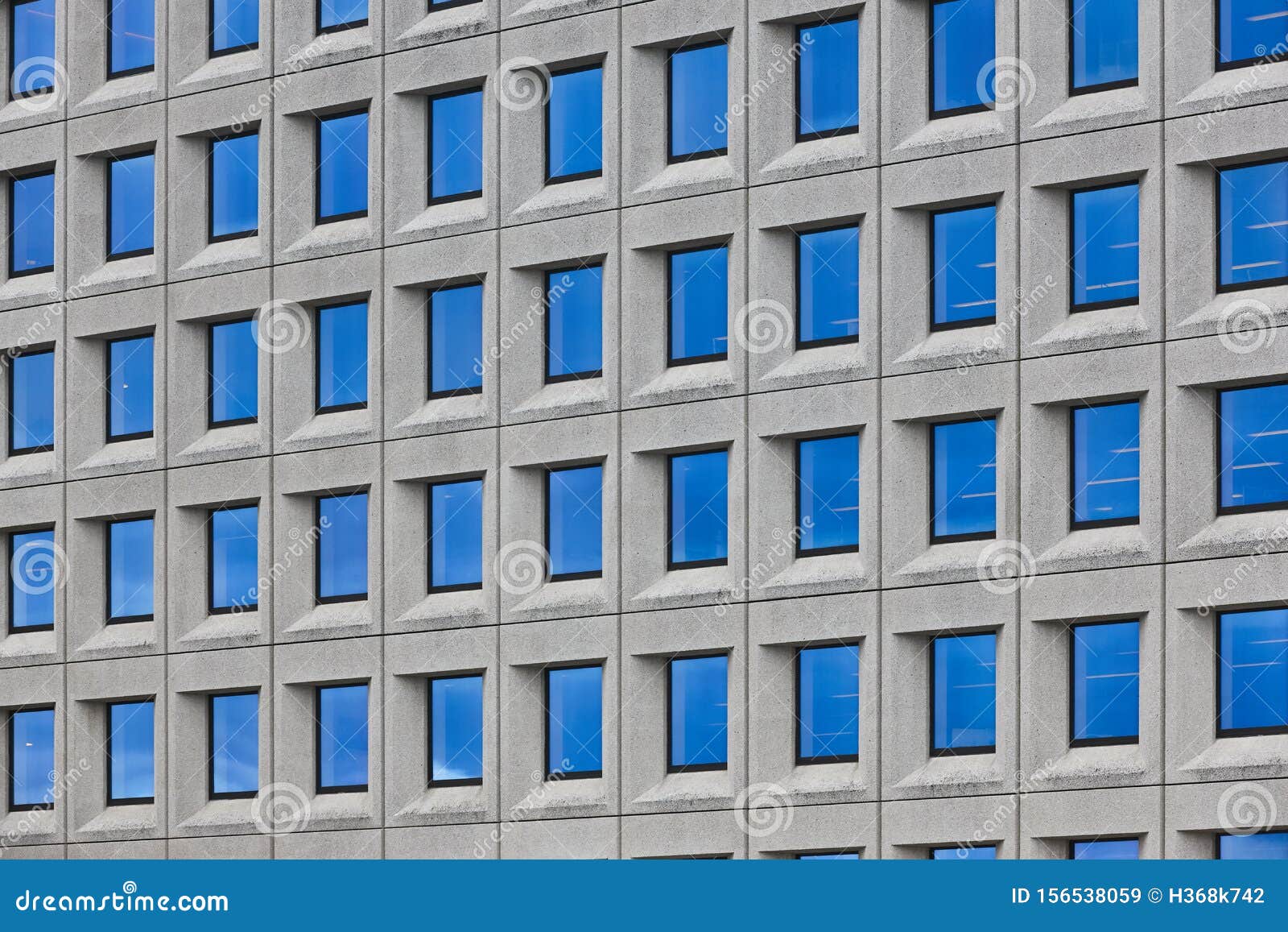 Modern Concrete Building Facade with Geometric Windows. Contemporary ...