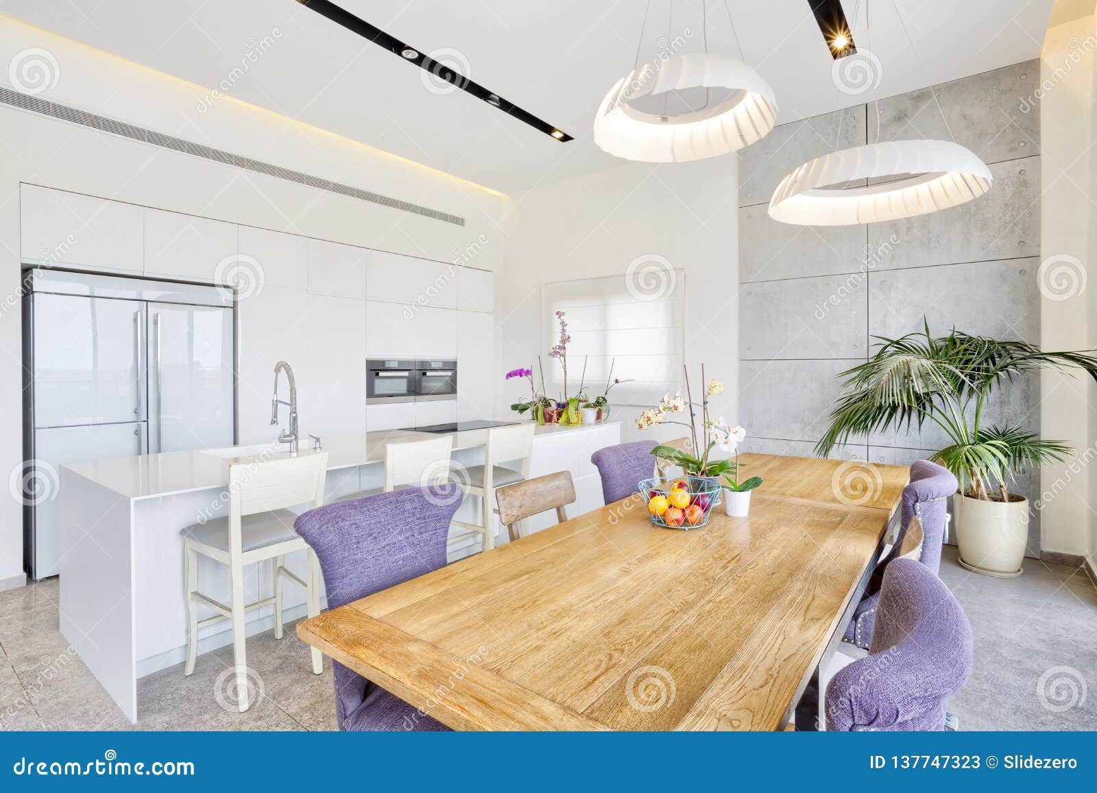 Design of Luxury Kitchen with Marble Island and Dinner Table Stock