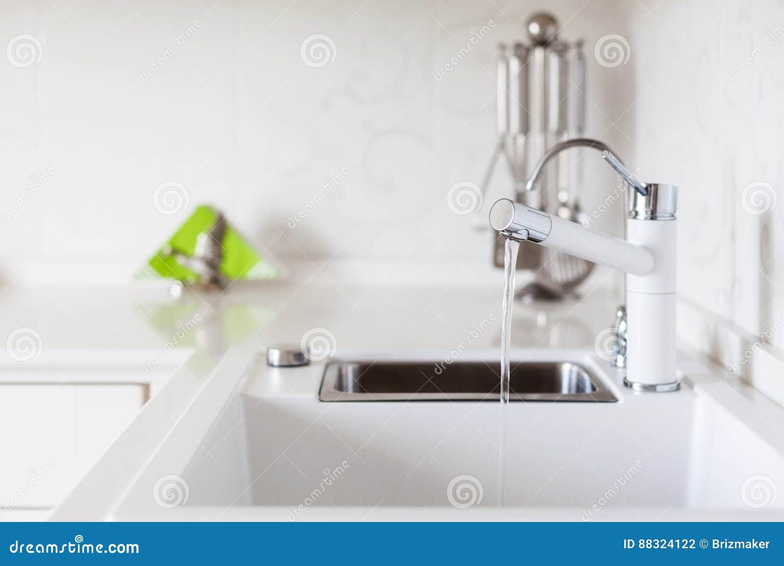 Modern Designer Chrome Water Tap Over White Kitchen Sink Stock Photo