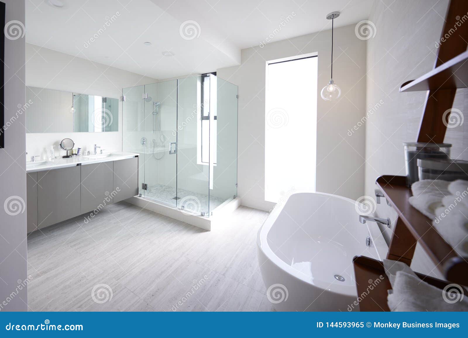 modern domestic bathroom with shower cabin and freestanding bath, sunlight, no people