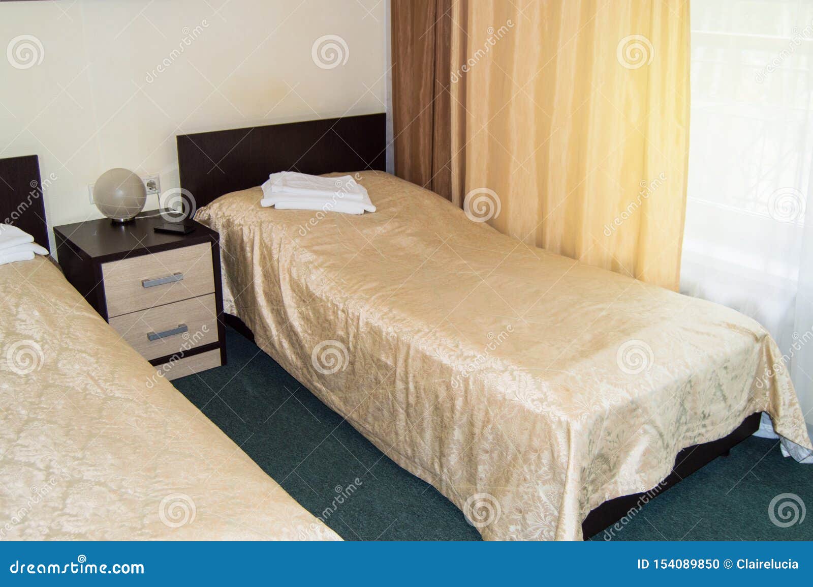 Modern Double Room With Two Single Beds Bedside Table Towels And