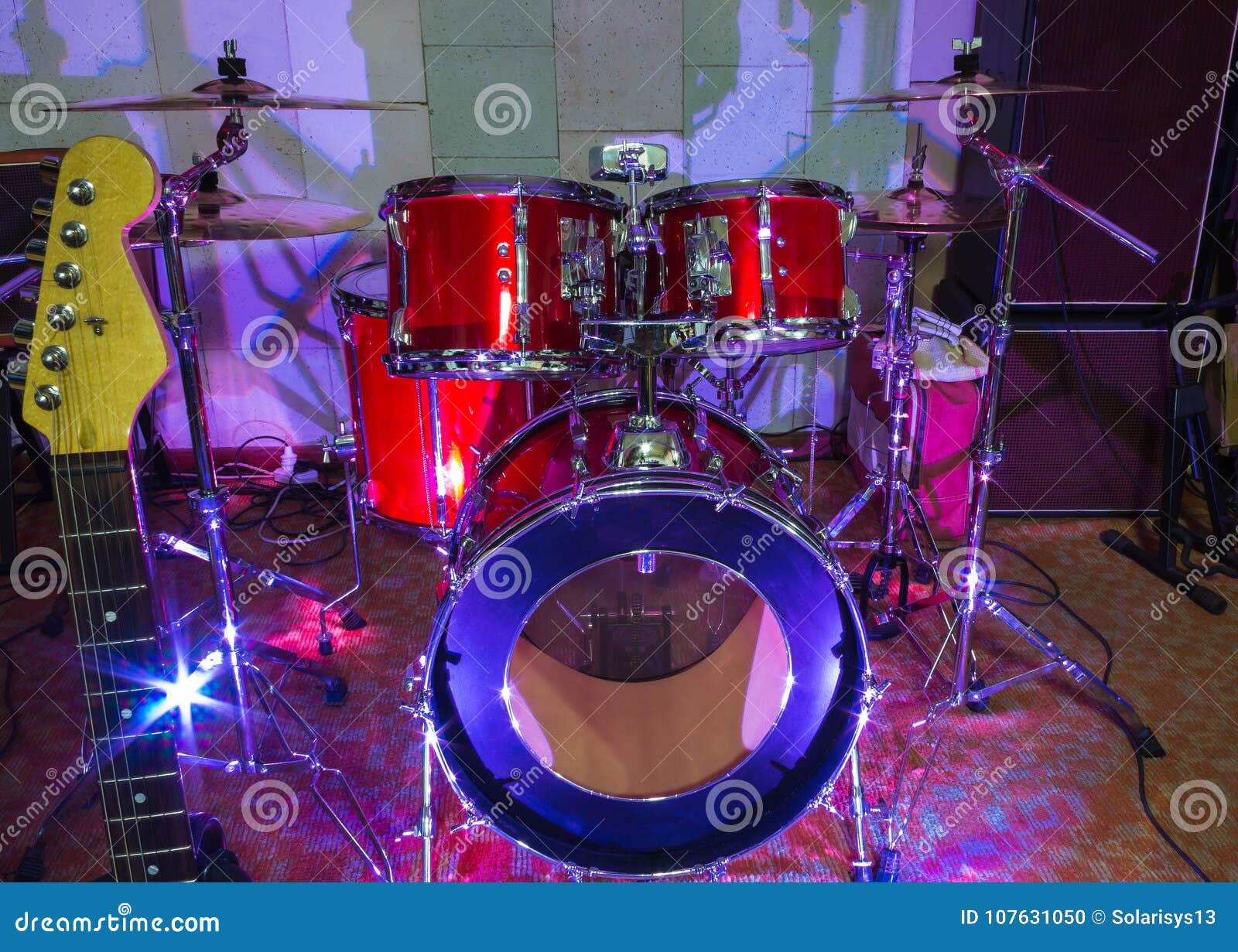 Modern Drum Set on Stage Prepared for Playing in Bright Blue Light