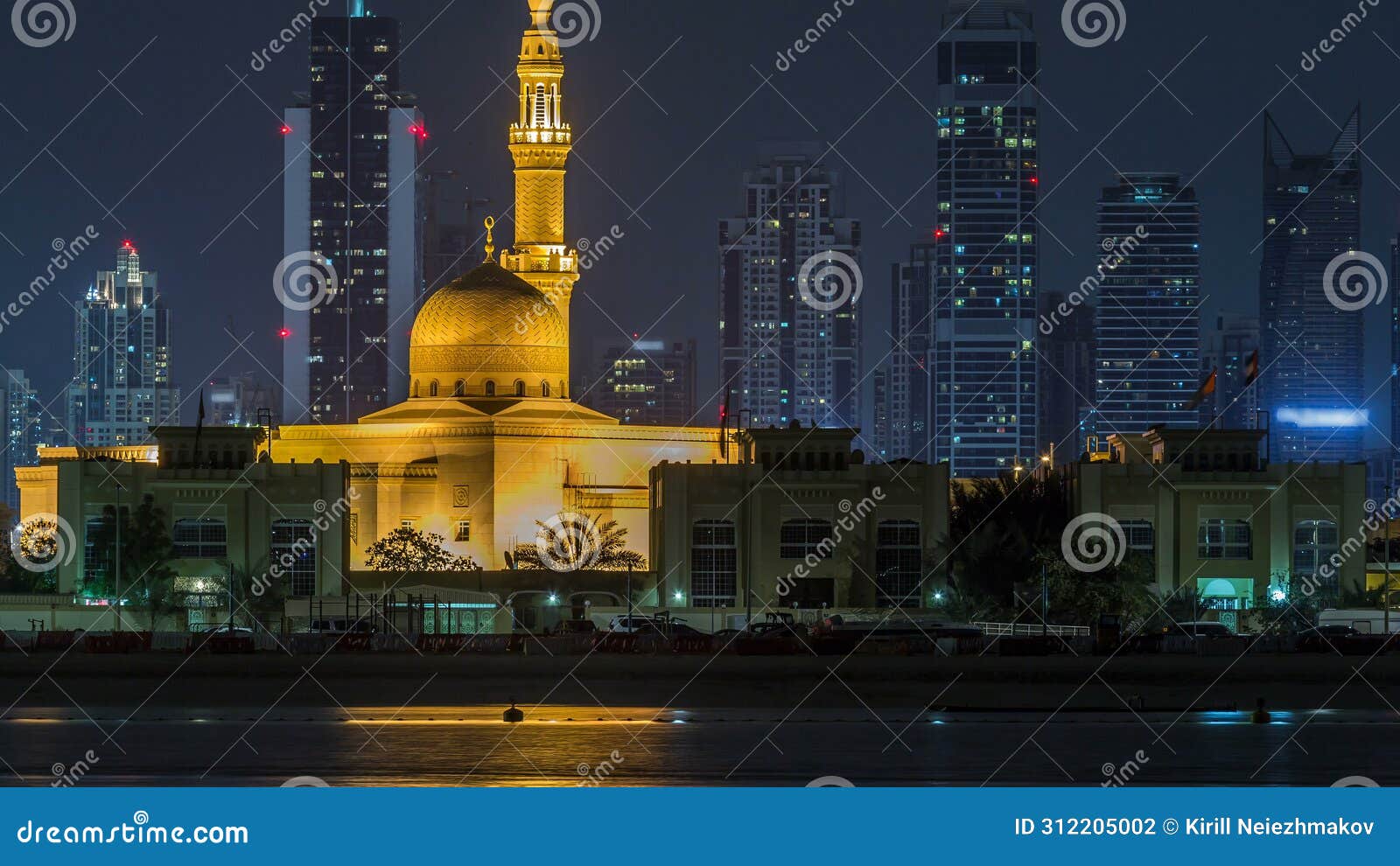 modern dubai city skyline timelapse with rashid al hadeeth mosque at night with illuminated skyscrapers over water