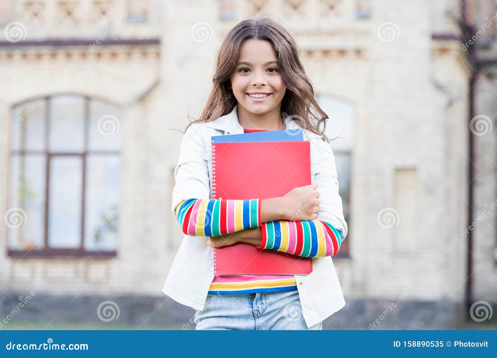 modern education. kid smiling girl school student hold workbooks textbooks for studying. education for gifted children