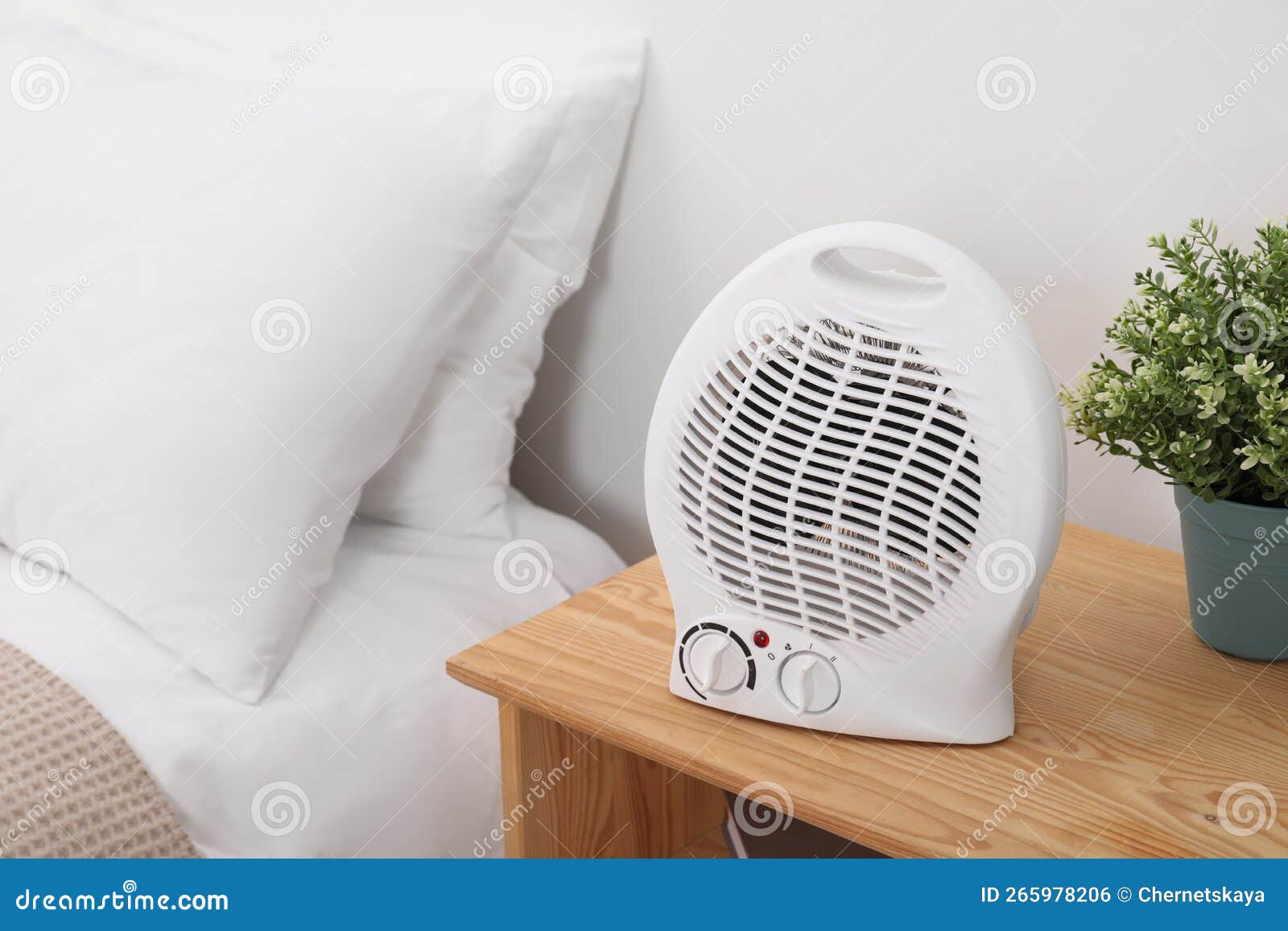 Modern Electric Fan Heater on Bedside Table Indoors Stock Photo Image