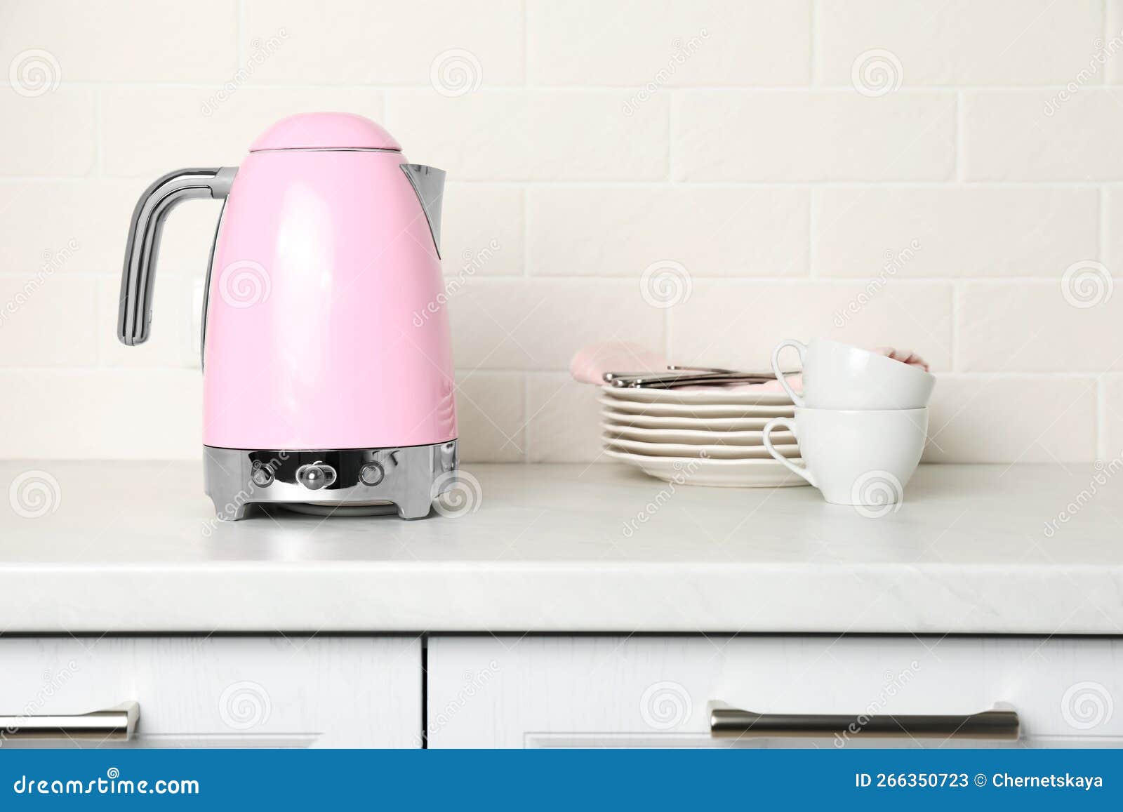 Modern Electric Kettle and Dishes on Counter in Kitchen Stock Image