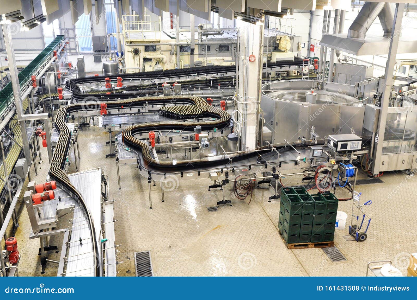 modern factory in the food industry - beer brewery - conveyor belt with beer bottles and machines for production