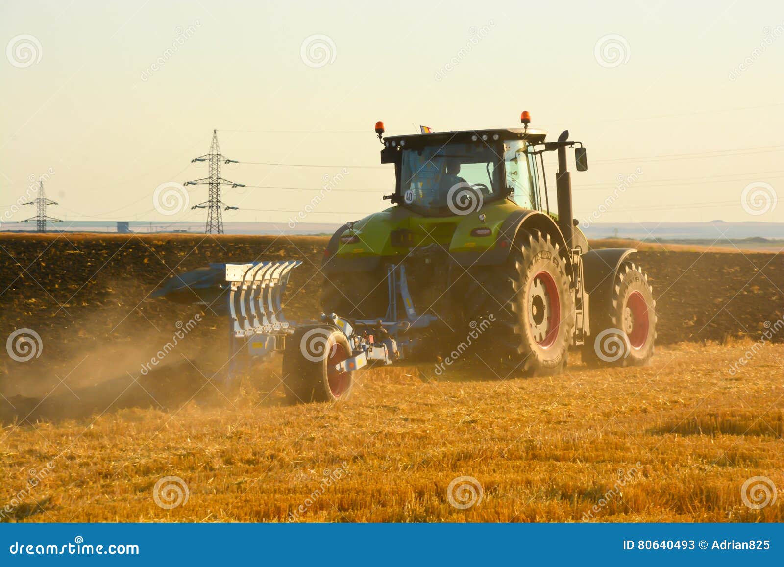 modern farming with tractor in plowed field