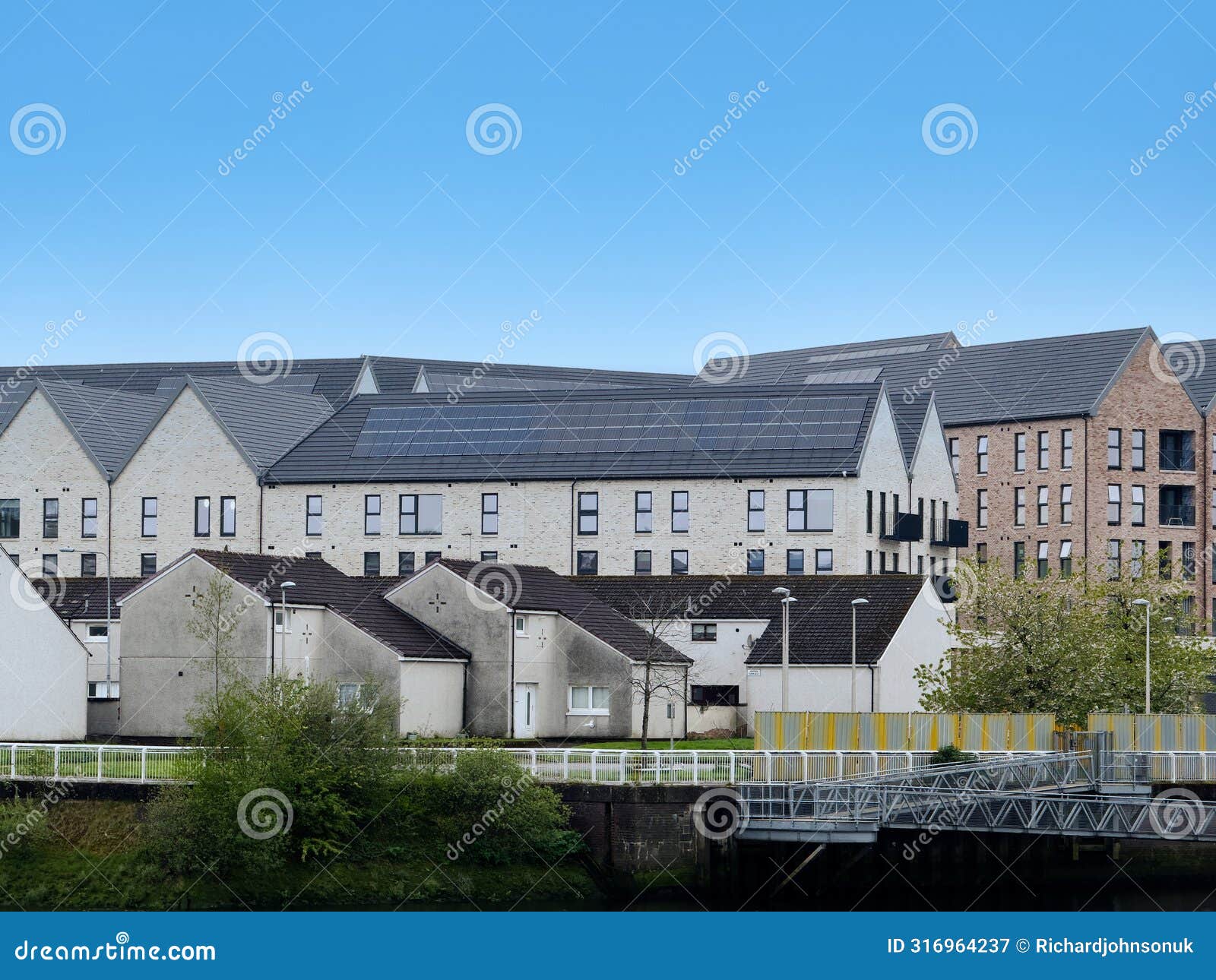 modern flats built next to old council houses in govan by the river clyde