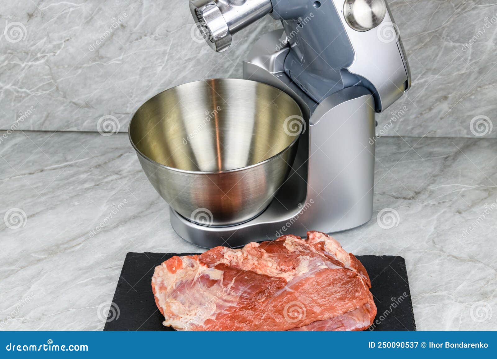 Modern Food Processor with Meat Grinder and Peace of Pork Meat on a