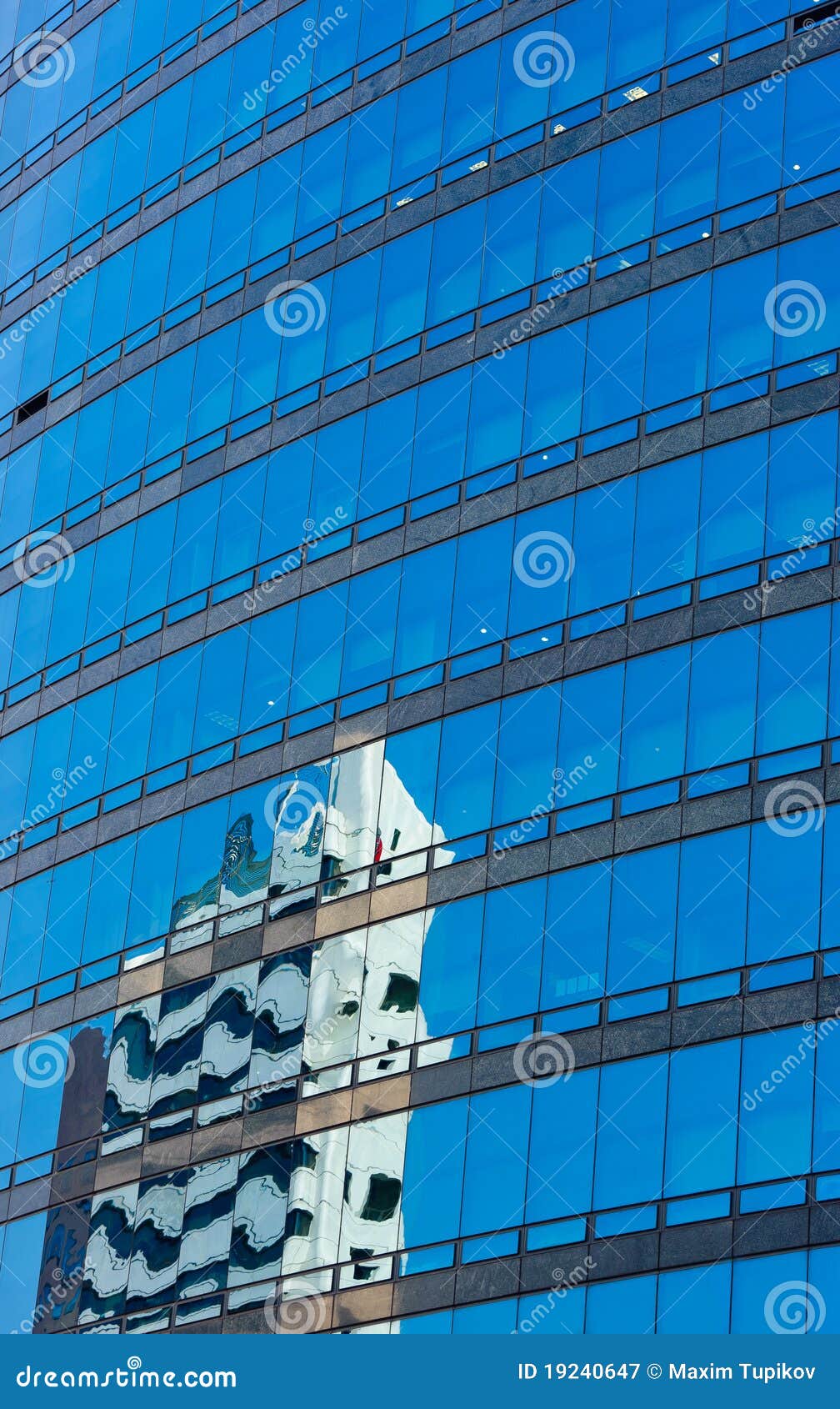 modern glass skycraper with building reflection