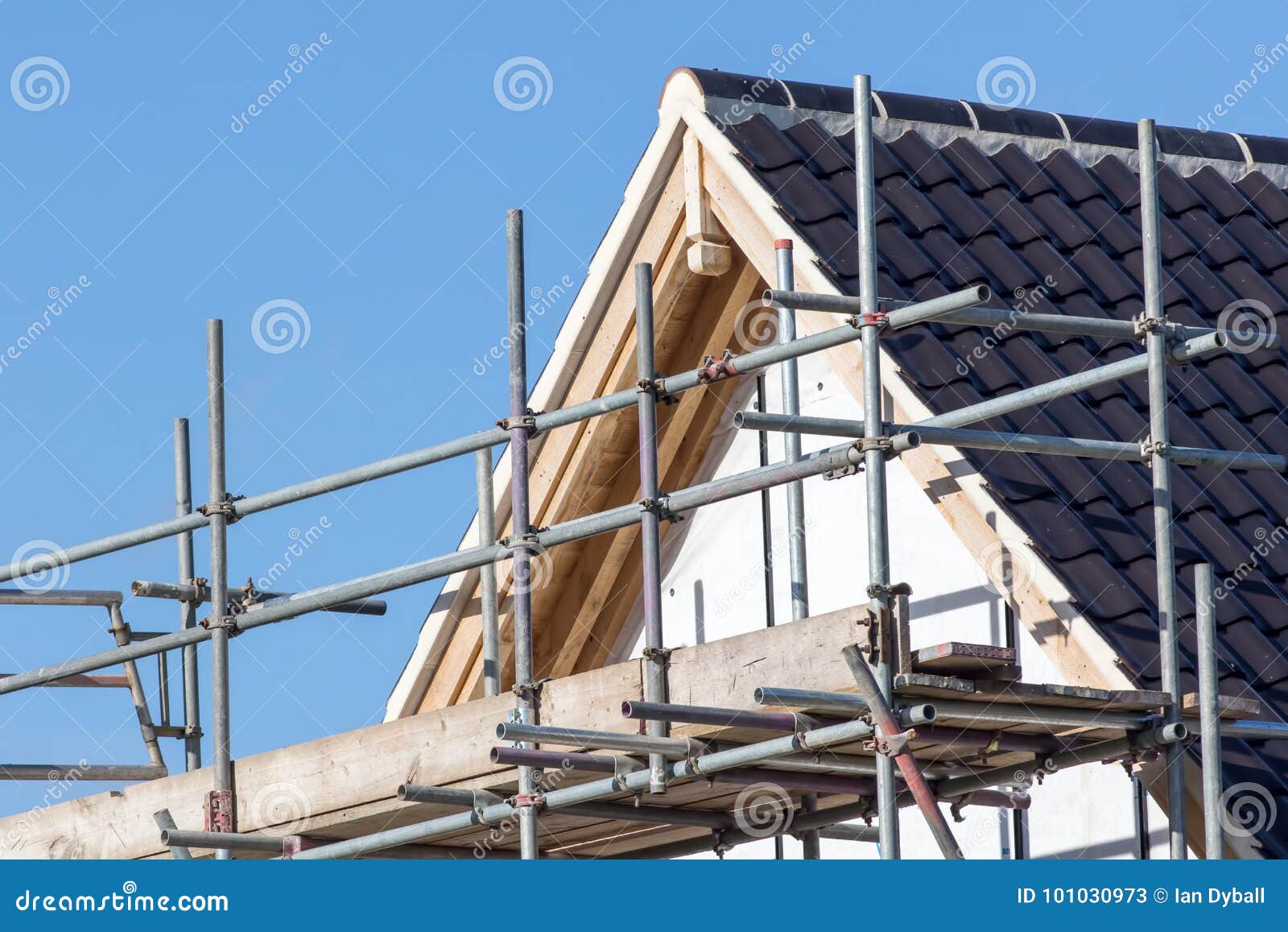 modern house roof construction with scaffold pole platform