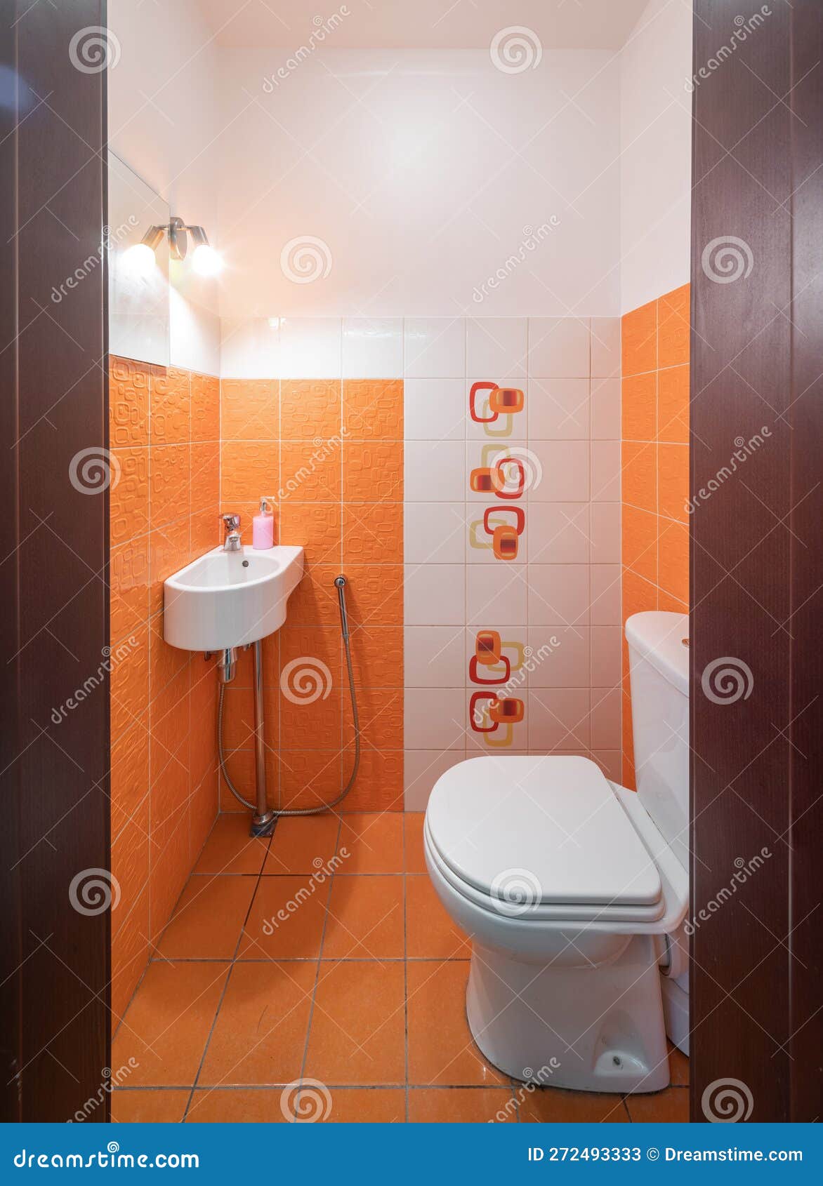 Modern Interior of Bathroom. Orange Tile. Sink and Toilet. Stock Image