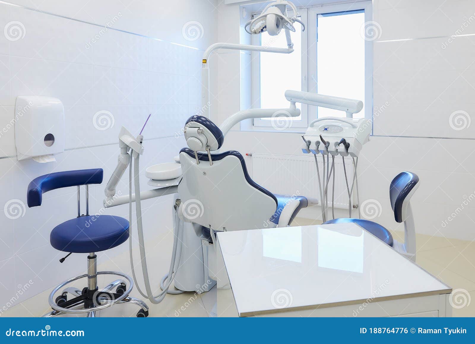 an interior of a dental office with white and blue furniture. dentistÃ¢â¬â¢s office