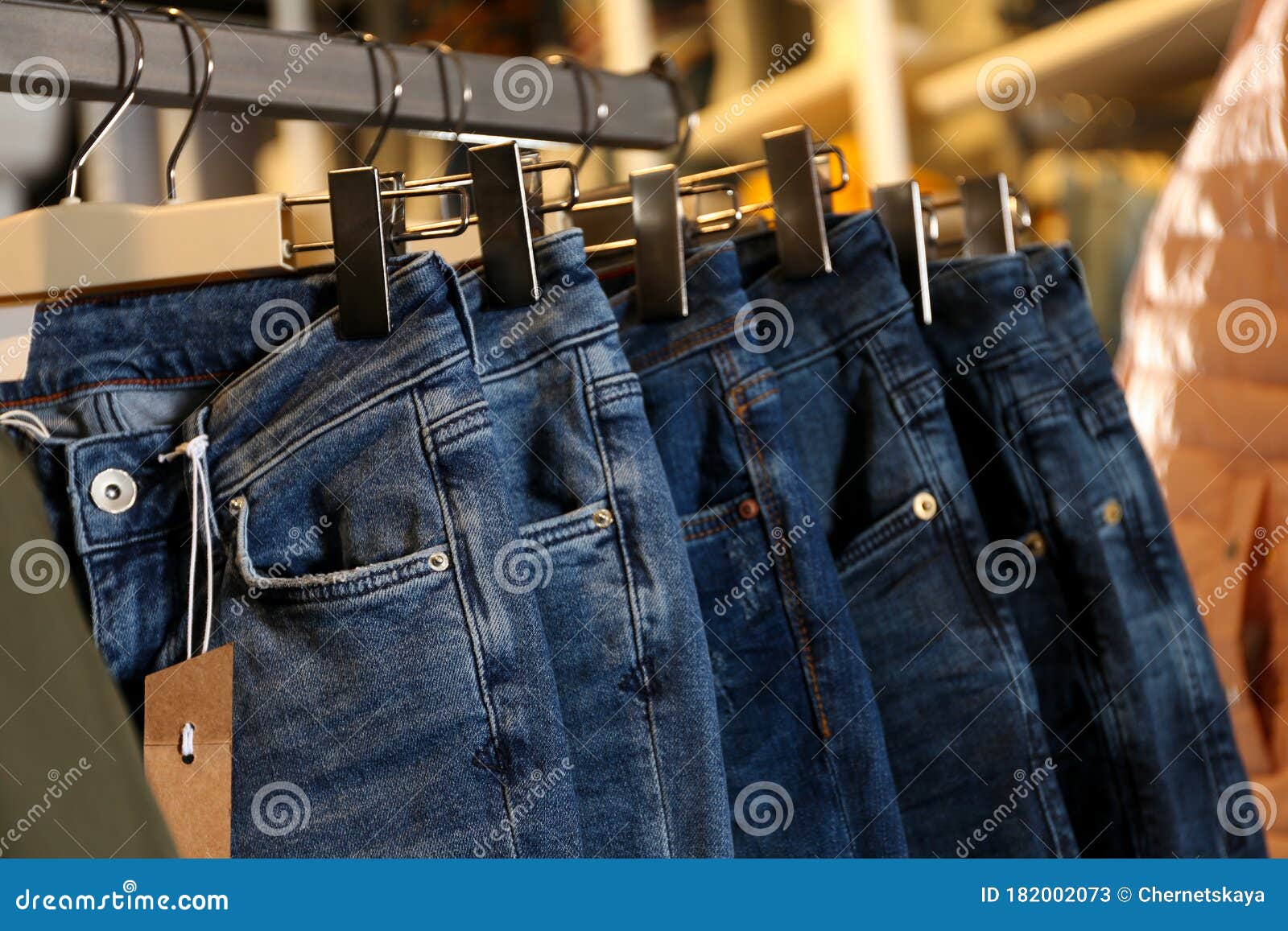 Modern Jeans Hanging on Clothing Rack in Shop Stock Image - Image of ...