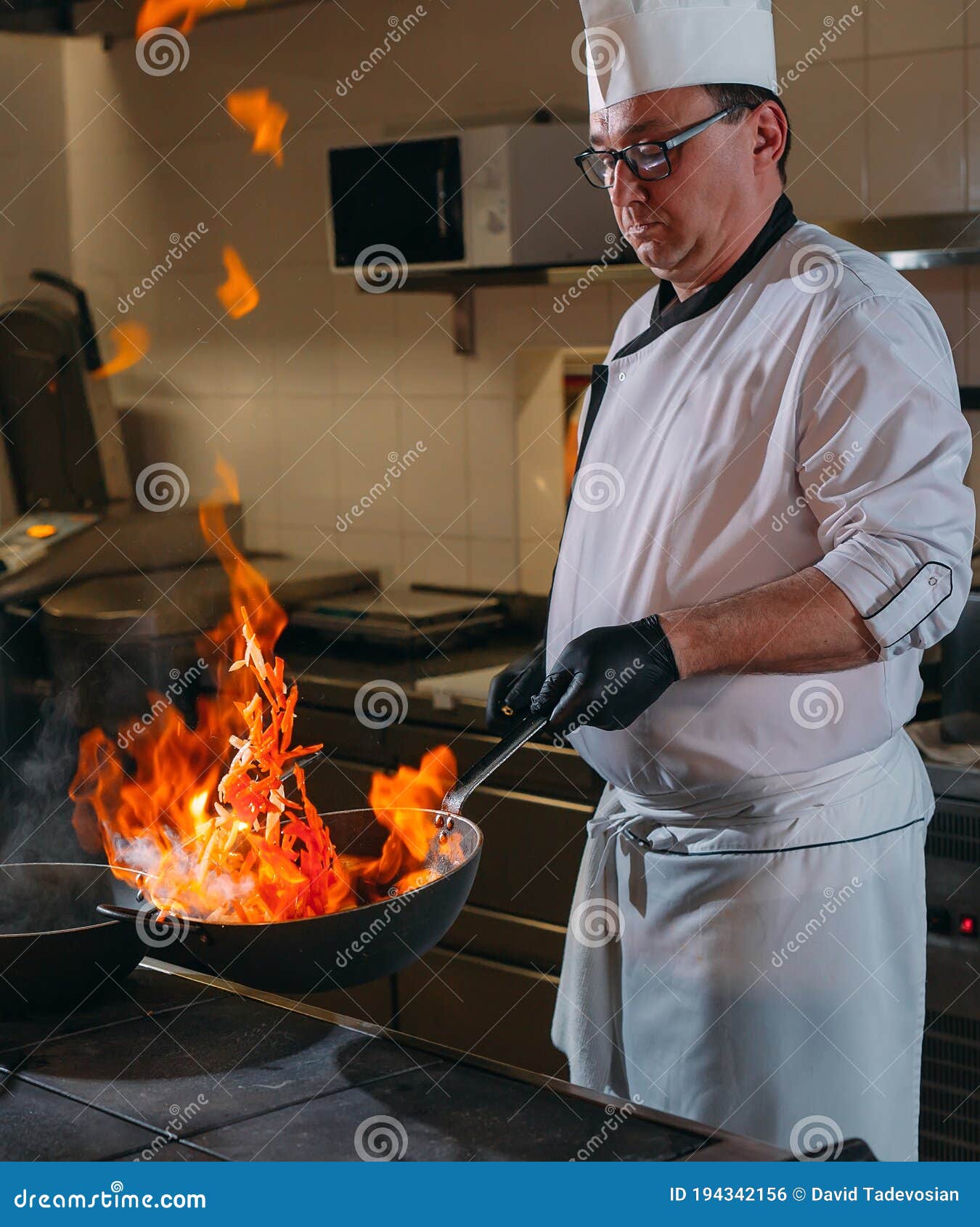 Modern Kitchen. Cooks Prepare Meals on the Stove in the Kitchen of the