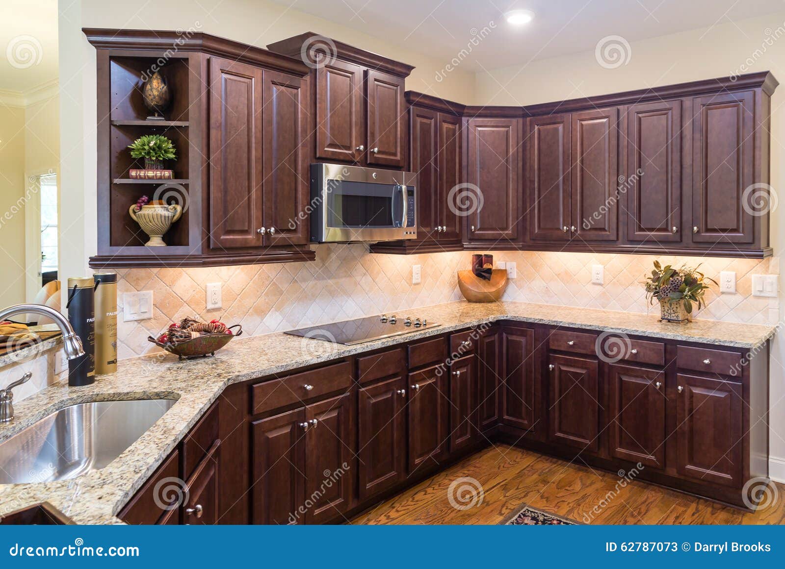 Modern Kitchen With Dark Cabinets And Wood Floor Stock Image