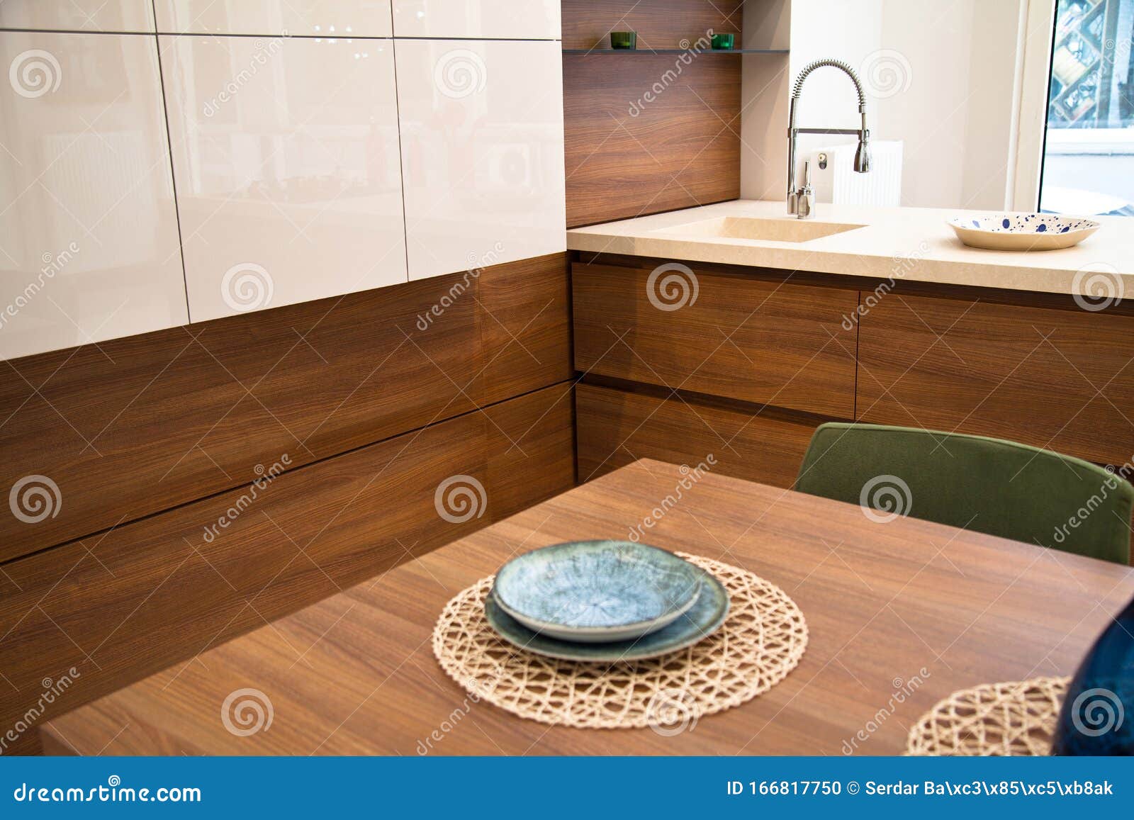 Modern Kitchen, Wooden Walnut Dining Table and Green Chairs Stock Photo