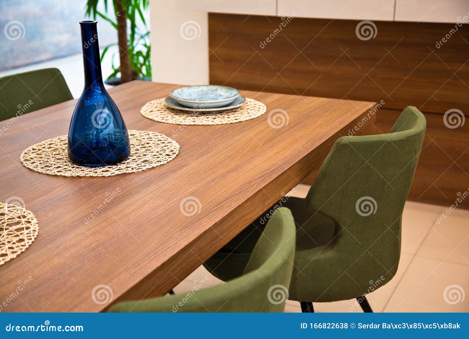 Modern Kitchen, Wooden Walnut Dining Table and Green Chairs Stock Photo