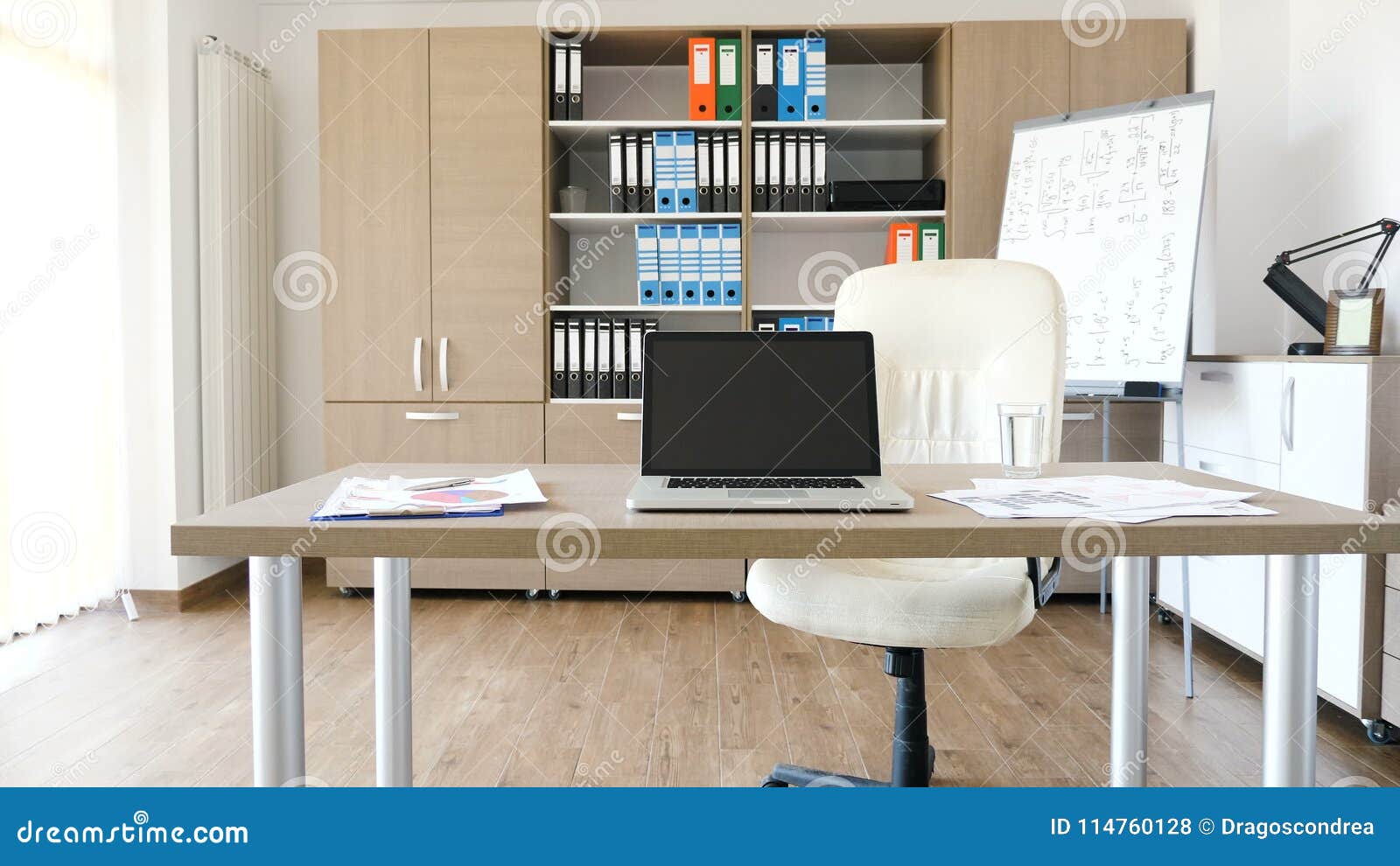 A Modern Laptop On A Desk In The Middle Of Modern Empty Office
