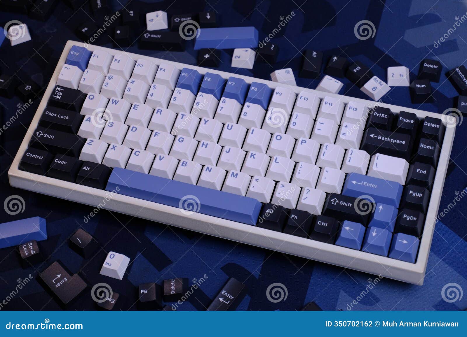 modern 75% layout white mechanical keyboard with minimalist theme of white, blue, and black keycaps on a minimal blue deskmat