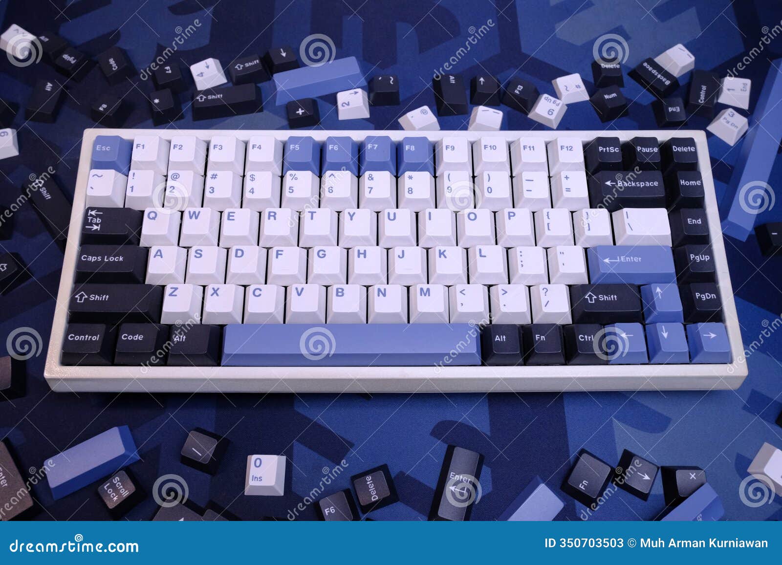 modern 75% layout white mechanical keyboard with minimalist theme of white, blue, and black keycaps on a minimal blue deskmat