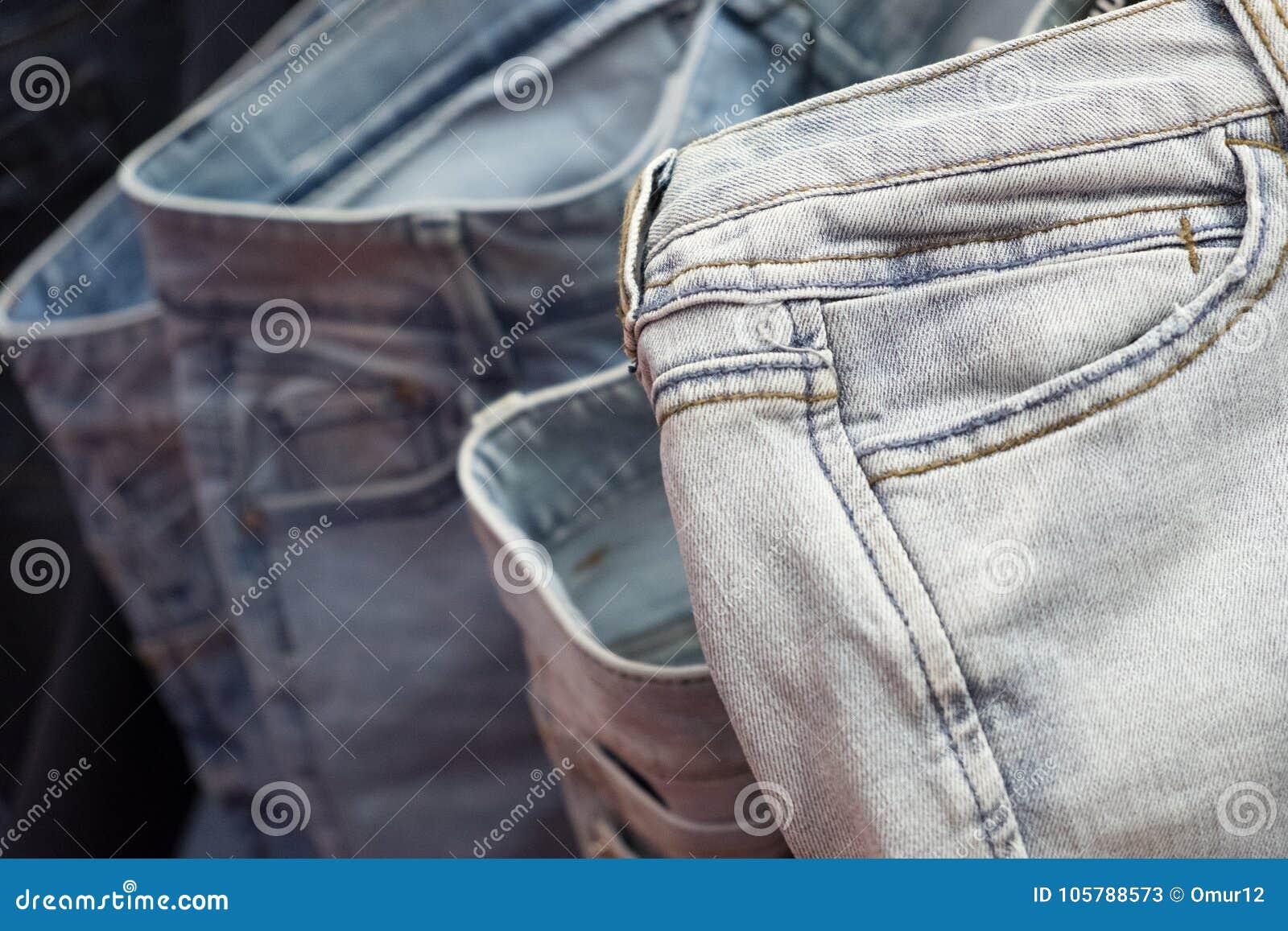 Row of hanged blue jeans stock image. Image of sewing - 105788573