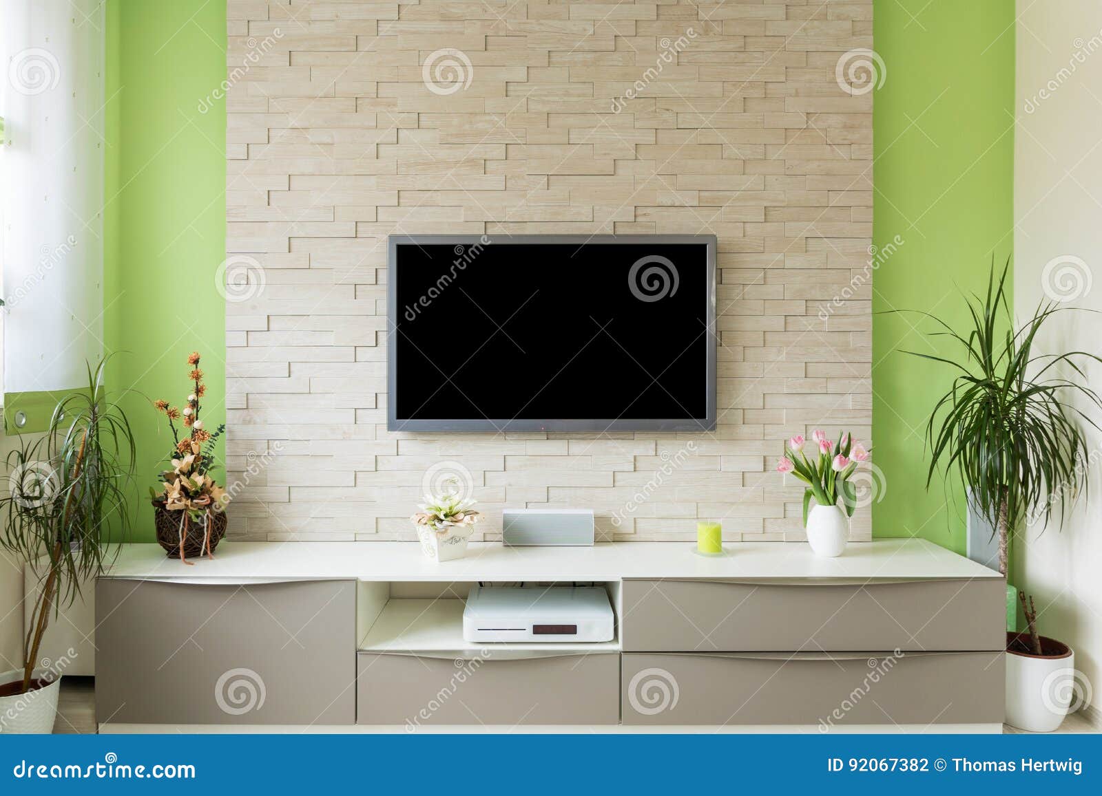 modern living room interior - tv mounted on brick wall with black screen