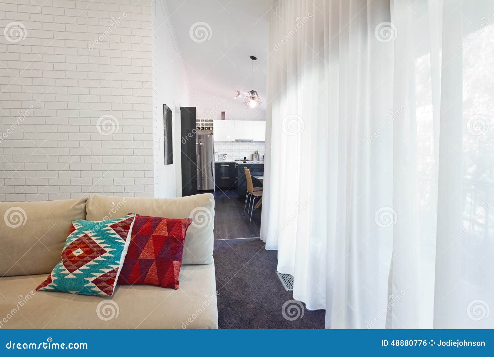 Modern Living Room Sofa and Sheer Curtains Horizontal Stock Photo