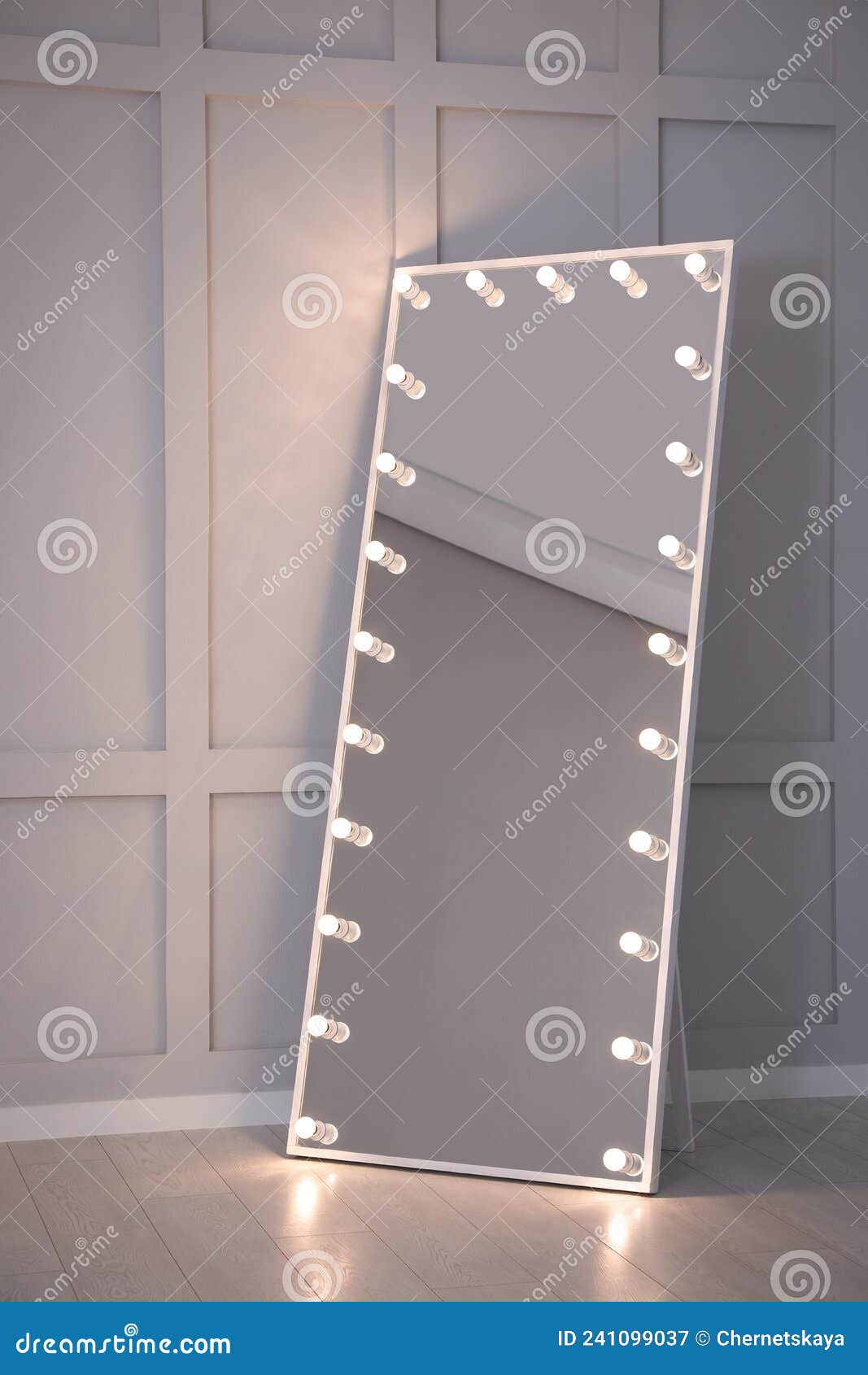 Modern Mirror with Light Bulbs Near Molding Wall in Room Stock Image