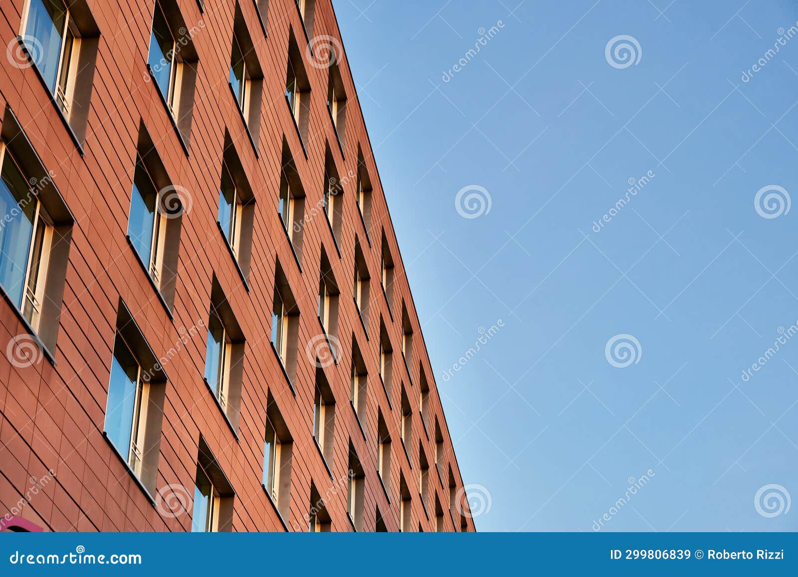 Modern Orange Bricked Facade with Windows Against the Sky is an Example
