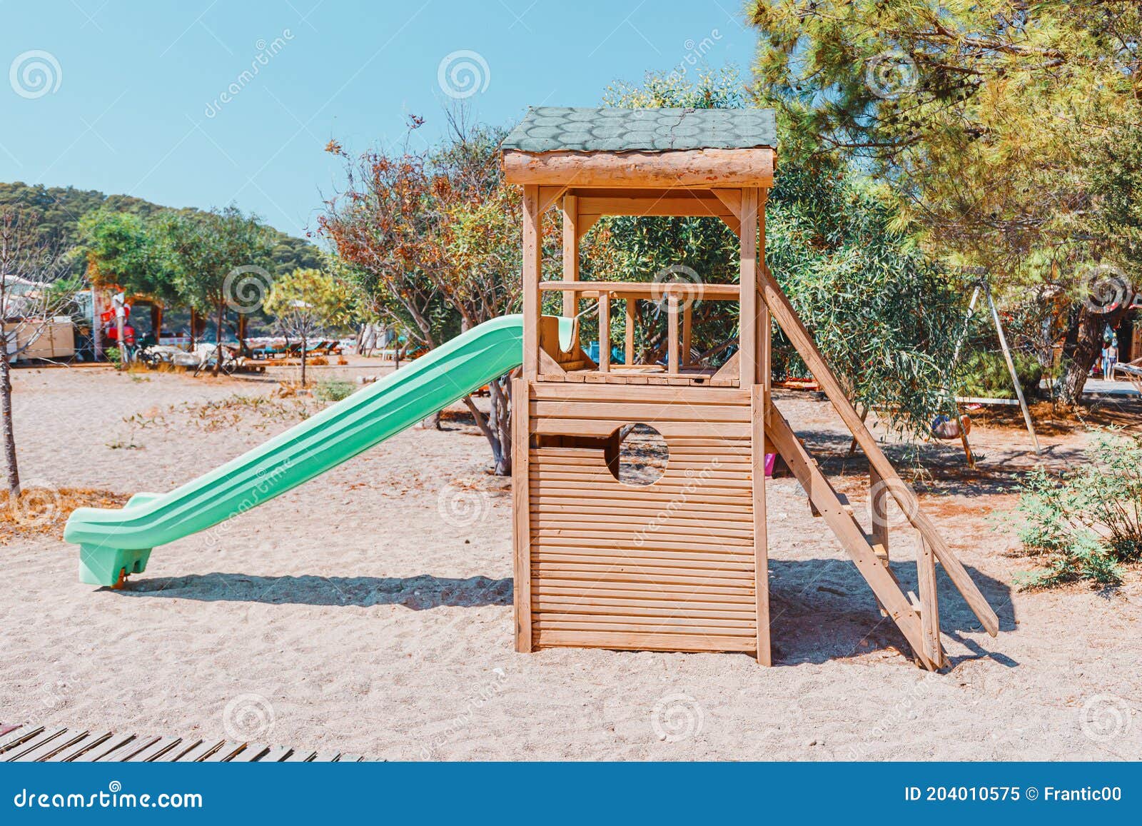 Plastic And Wooden Children`s Slide In City Park Or Kindergarten