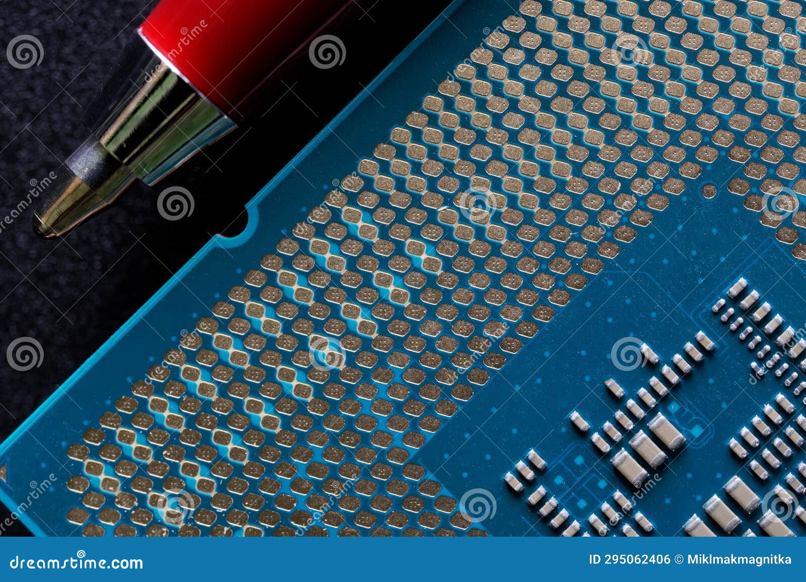 modern powerful multi-core personal computer processor compared to the tip of a fountain pen. black background. computer assembly