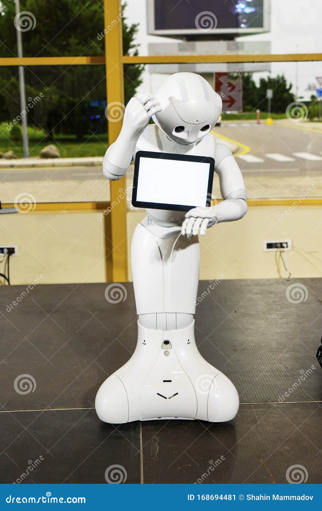 modern robotic technologies. electronics show-exhibition of consumer electronics. the robot shows emotion. raises hands upward,