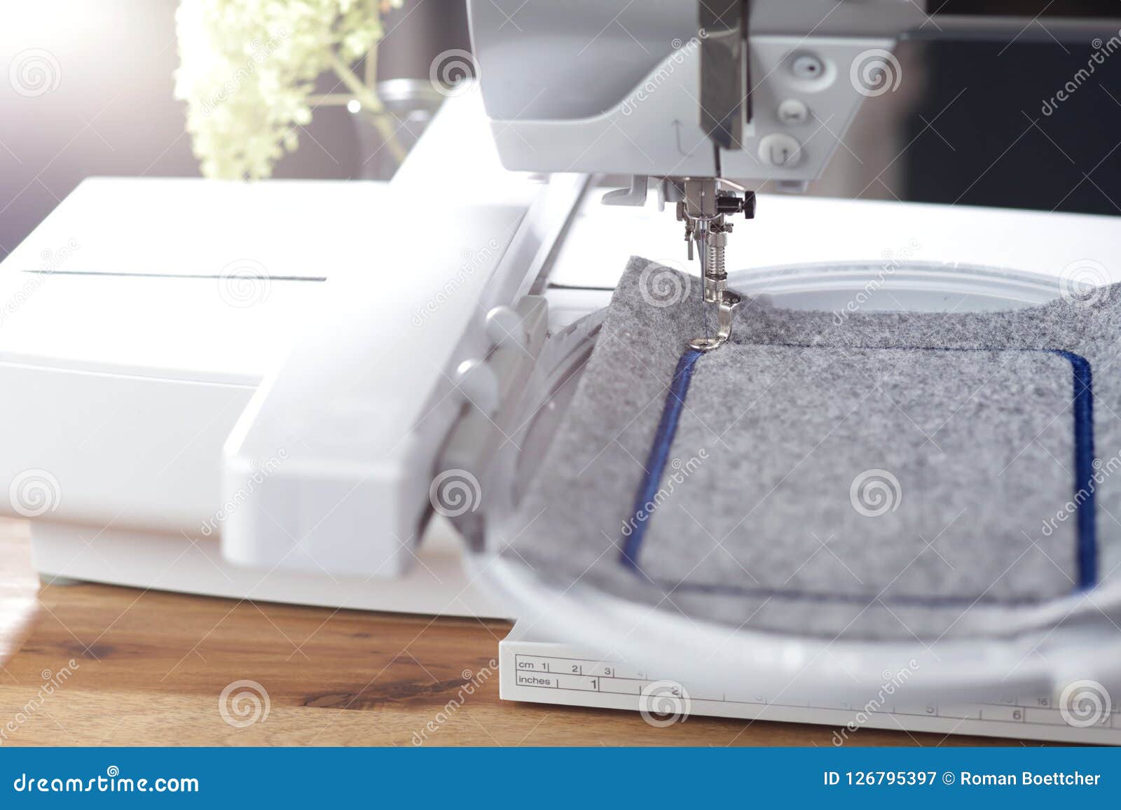 Modern Sewing Machine with Embroidery Unit in Bright Light Stitching a