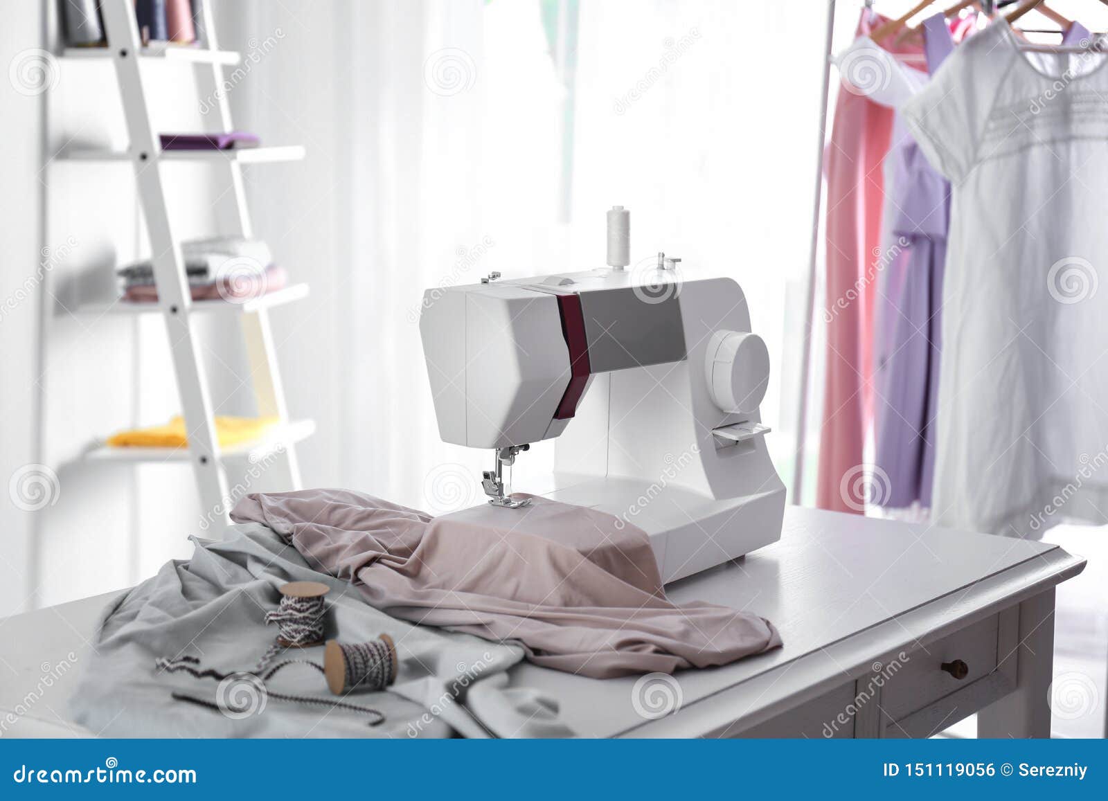 Modern Sewing Machine with Fabric and Tailor S Supplies on Table in