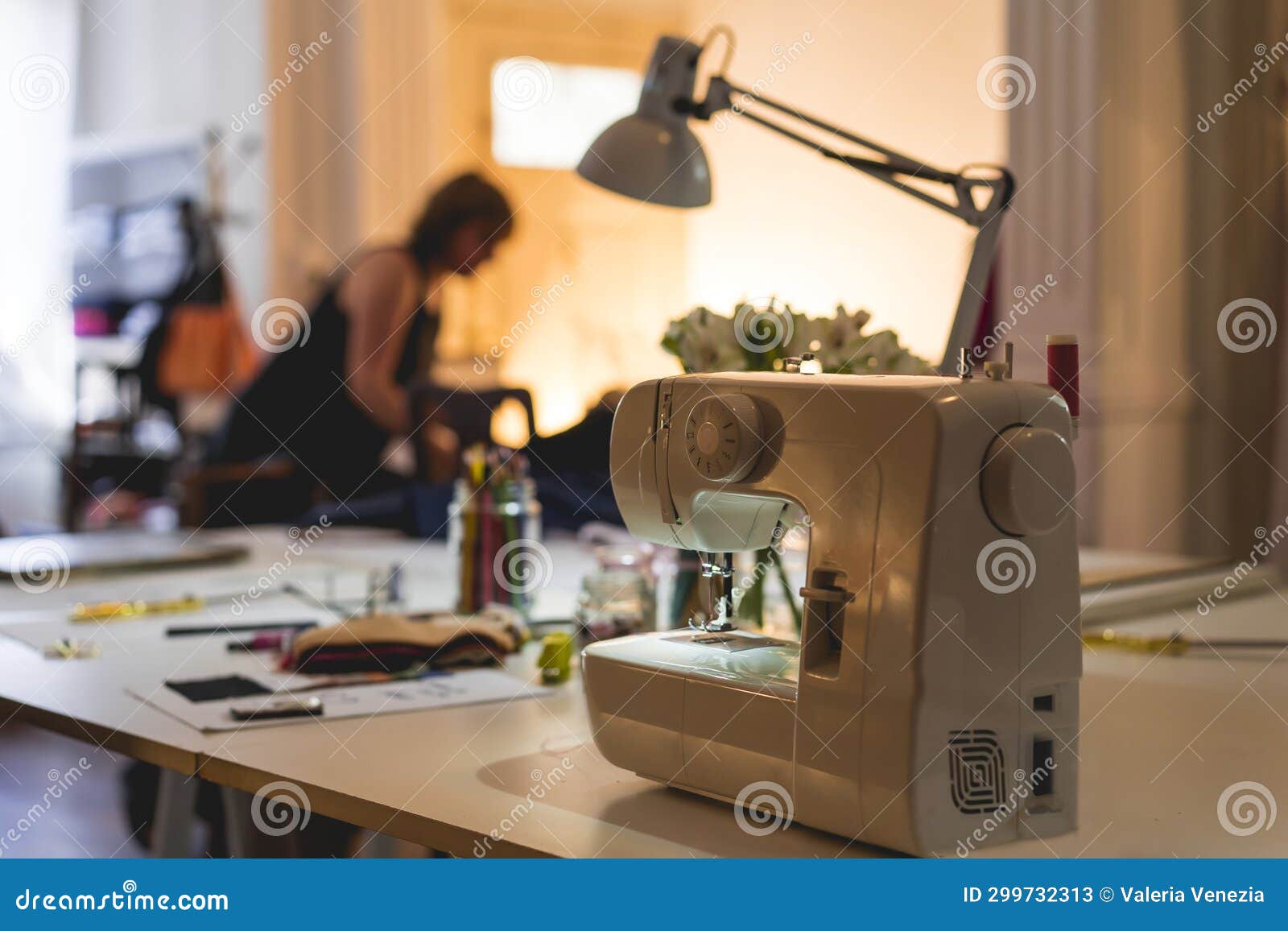 Modern Sewing Machine on Table at Fashion Studio and Showroom Stock