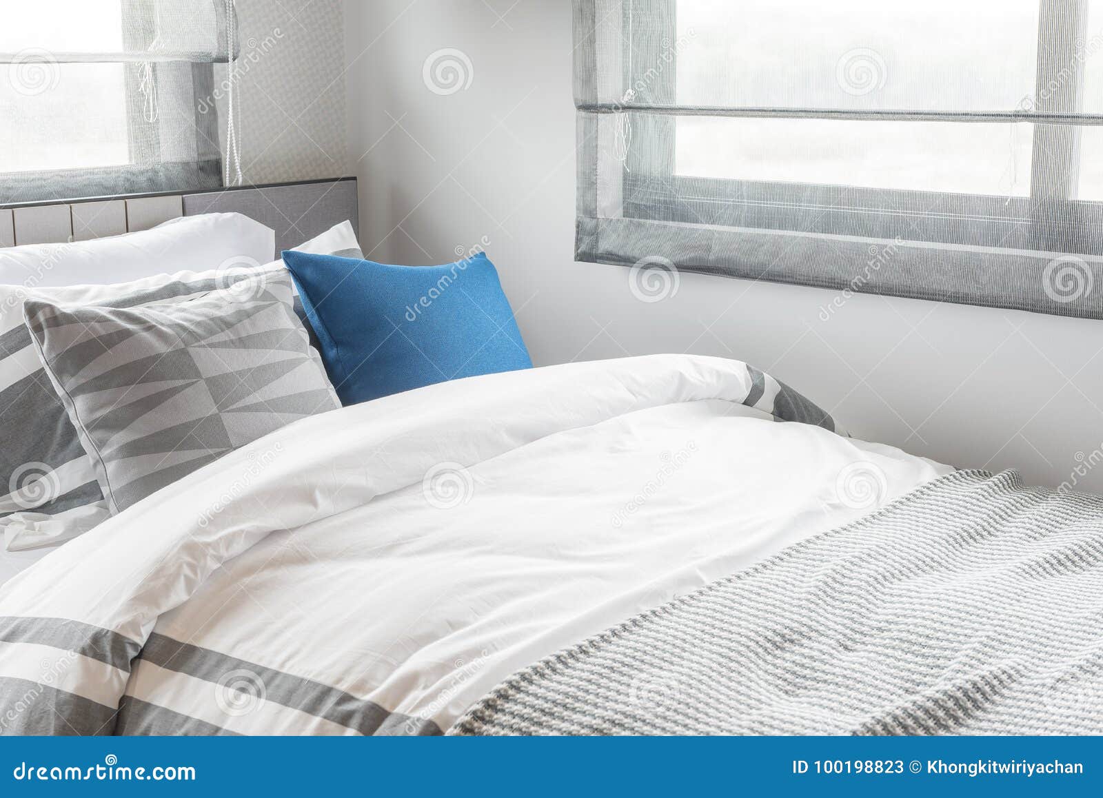 Modern Single Bed With Set Of Pillows In Modern Bedroom