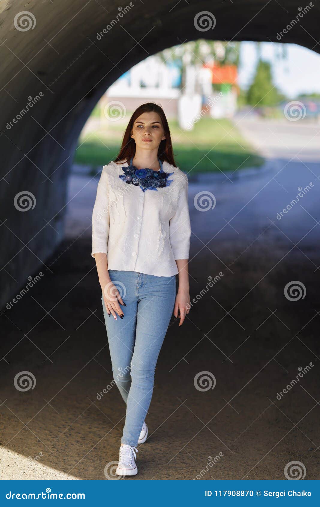 stylish beautiful girl defiles in a white jacket