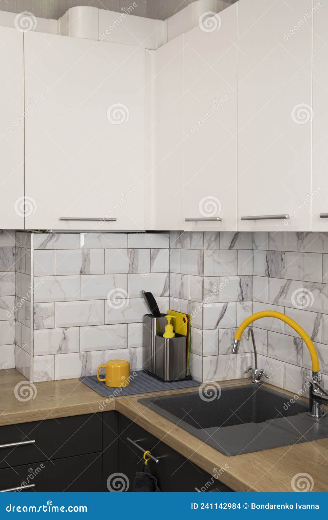 Modern and Stylish White and Grey Kitchen with Yellow Accents Stock
