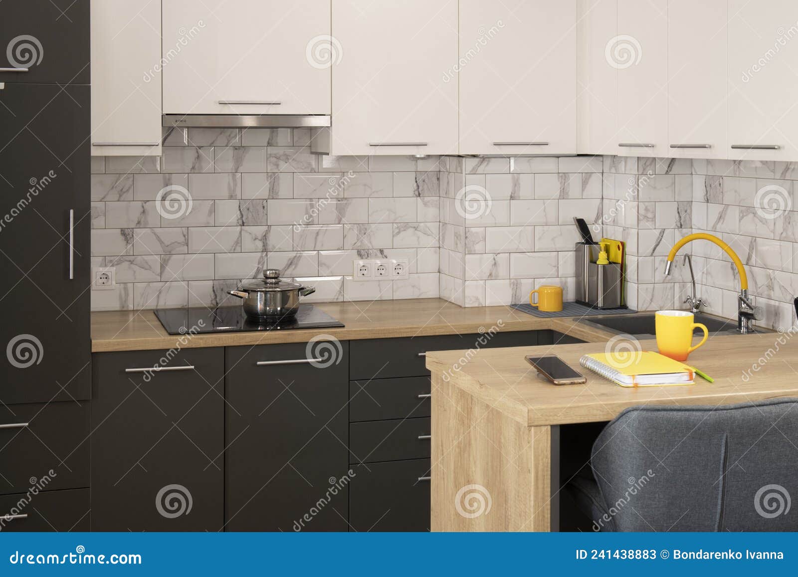 Modern and Stylish White and Grey Kitchen with Yellow Accents Stock