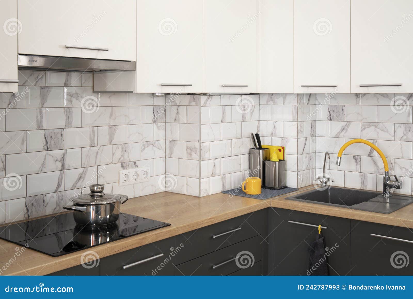 Modern and Stylish White and Grey Kitchen with Yellow Accents Stock