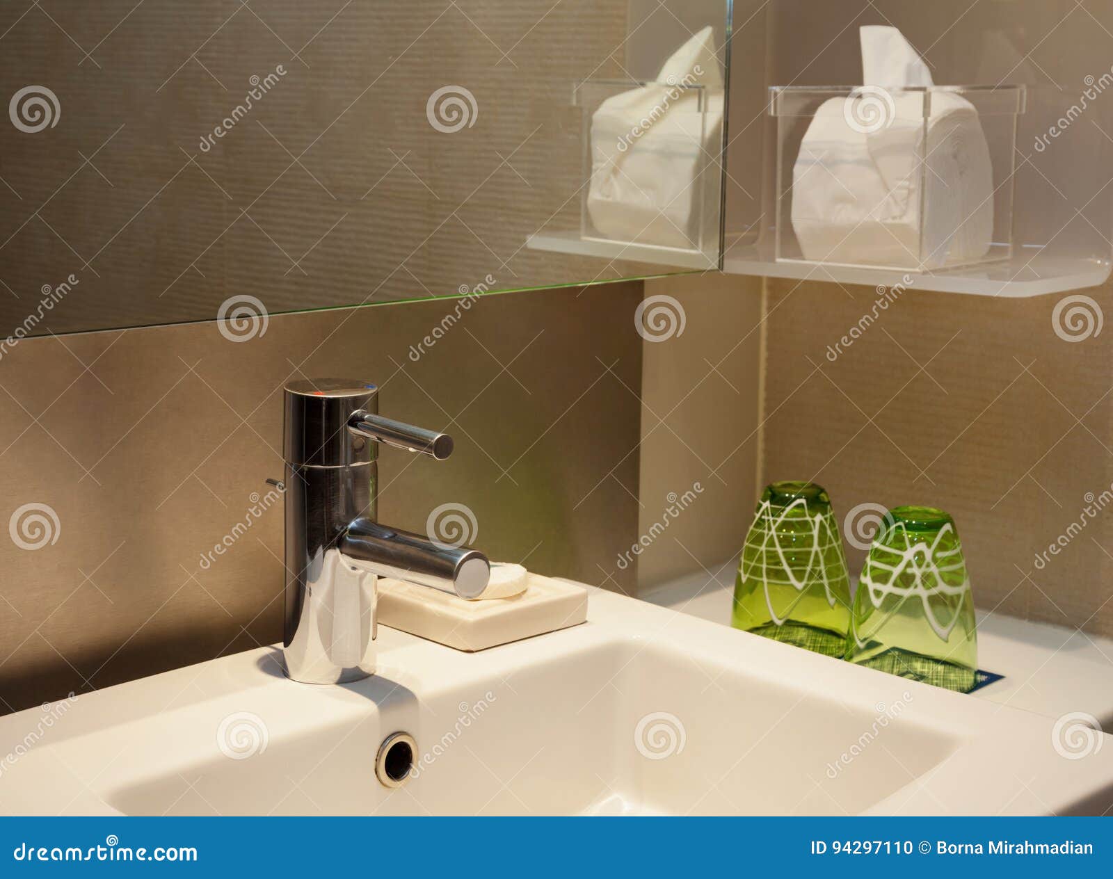 Modern Toilet Water Faucet With Mirror And Brown Tiles Stock Photo