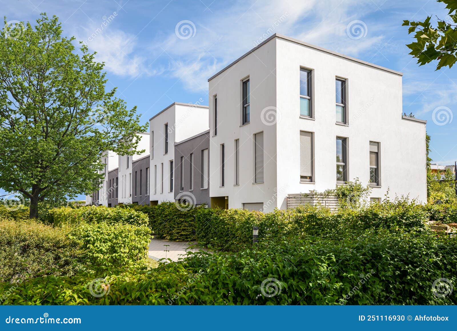 modern townhouses in a residential area, new apartment buildings with green outdoor facilities in the city