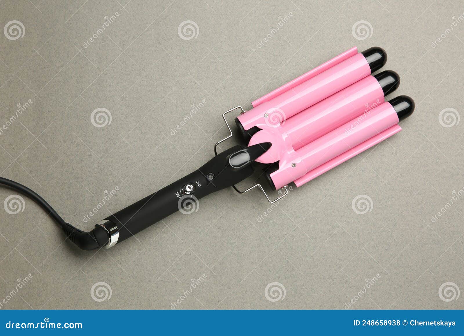 Modern Triple Curling Hair Iron on Grey Background, Top View Stock