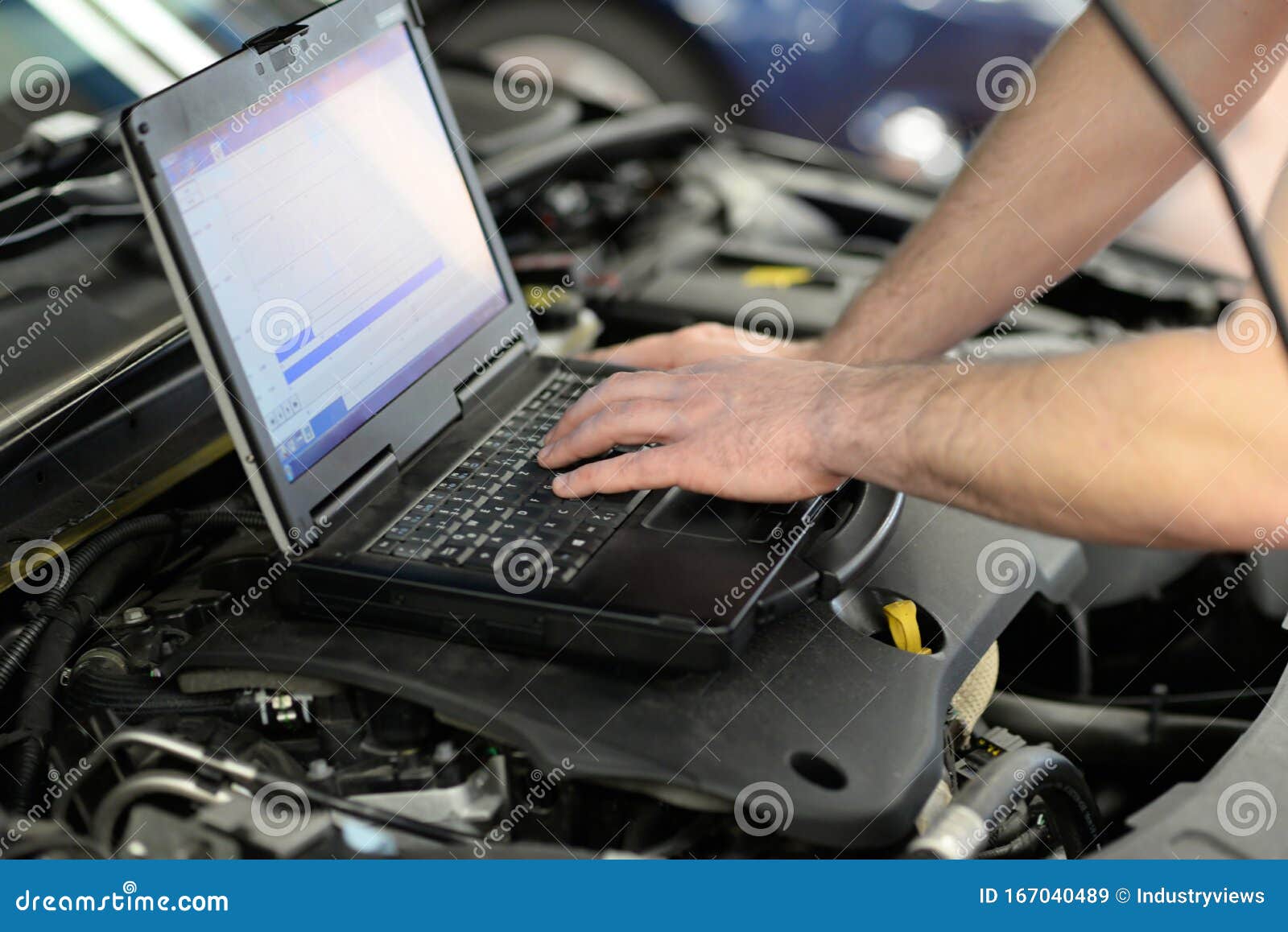 Modern Vehicle Diagnosis With Computer In A Garage Mechanic Inspects