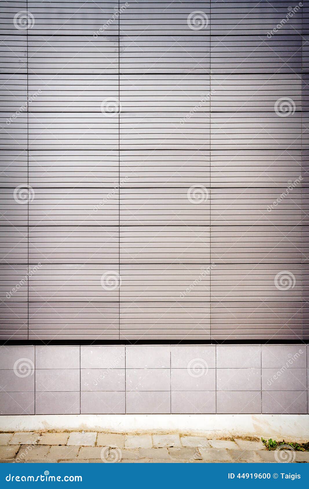 Modern wall. Modern tile wall and old sidewalk