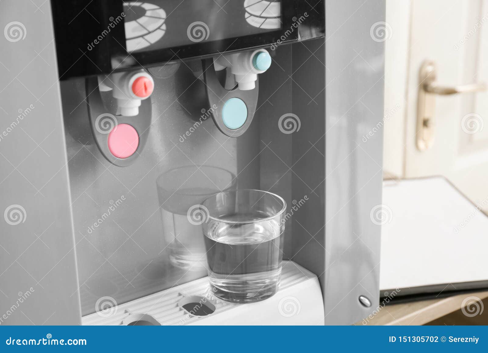 Modern Water Cooler with Glass on Table in Office Stock Photo Image