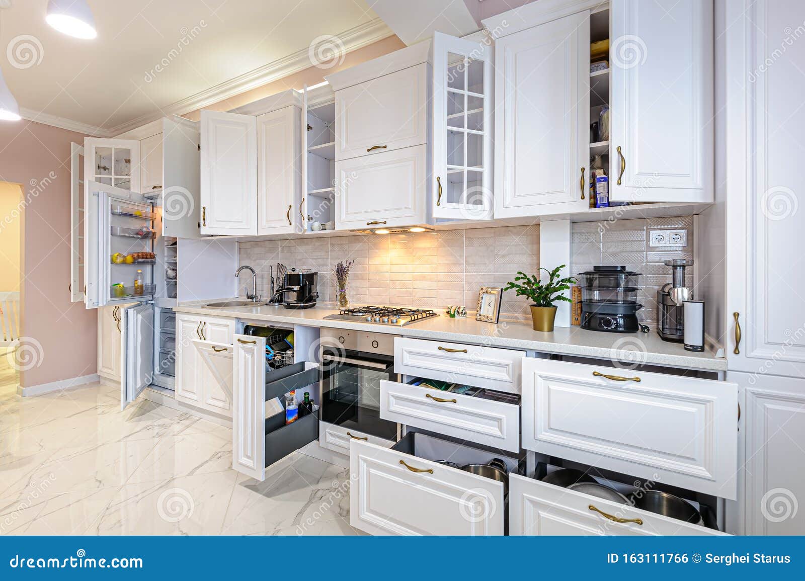 Modern White Kitchen Interior with Open Doors and Drawers Stock Photo