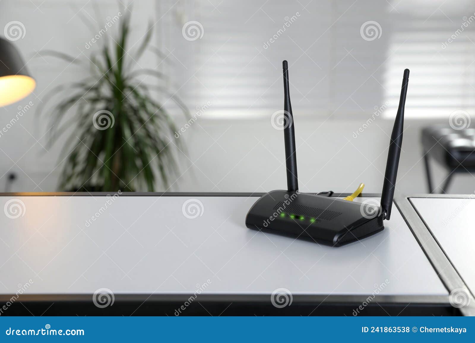 Modern WiFi Router on Table Indoors. Space for Text Stock Photo